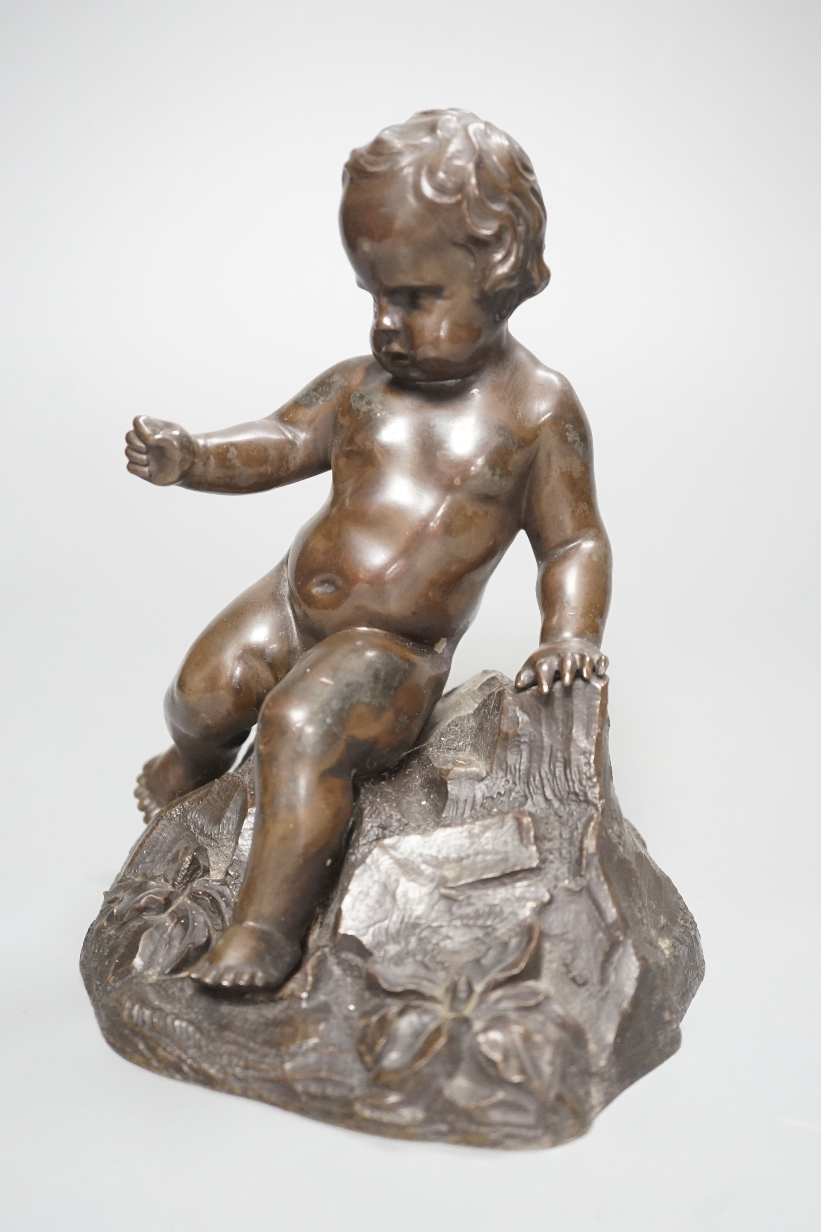 A bronze of a seated boy, height 17cm